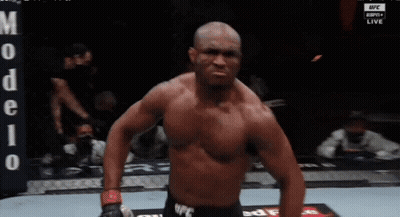a shirtless fighter stands in front of a banner that says ufc live
