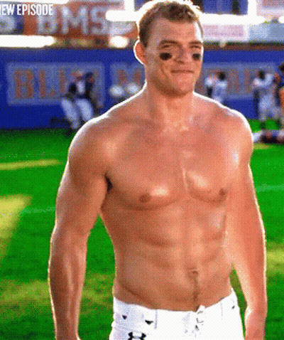 A Shirtless Football Player Stands On A Field With A Bms Sign In The Background GIF
