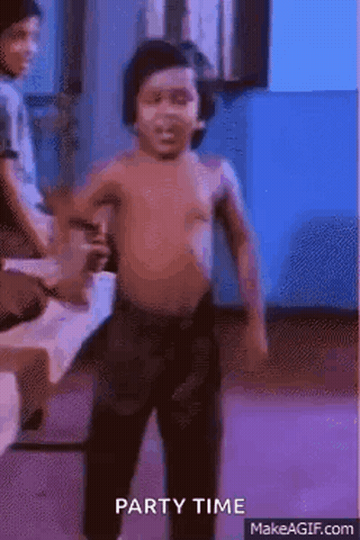 A Shirtless Little Boy Is Dancing In A Room With A Blue Background . GIF