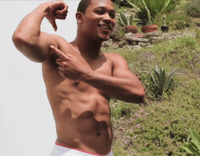 A Shirtless Man Flexes His Muscles And Points At His Armpit GIF