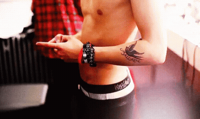 A Shirtless Man Has A Tattoo Of A Bird On His Arm GIF