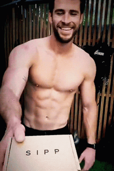 A Shirtless Man Holding A Box That Says Sipp GIF