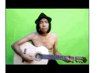A Shirtless Man In A Black Hat Is Playing A Guitar Sticker