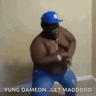A Shirtless Man In A Blue Hat Is Dancing In A Living Room . GIF