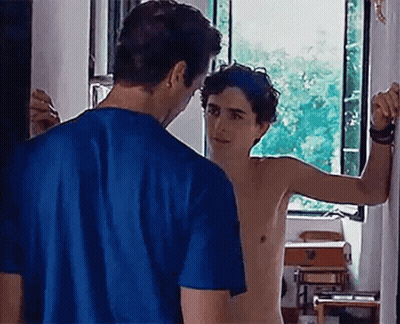 A Shirtless Man In A Blue Shirt Is Standing Next To A Shirtless Man In A Blue Shirt . GIF
