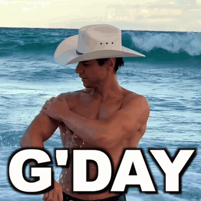 A Shirtless Man In A Cowboy Hat Stands On The Beach With The Words G'day Below Him GIF