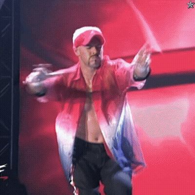 A Shirtless Man In A Red Shirt And Hat Is Dancing On A Stage GIF