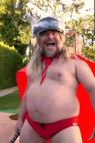 A Shirtless Man In A Red Speedo And A Viking Helmet GIF