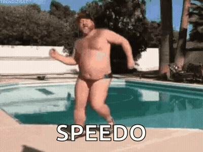 A Shirtless Man In A Speedo Is Jumping Into A Pool . GIF