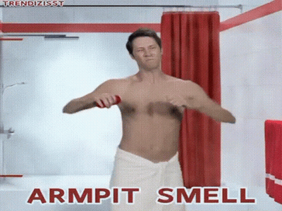 A Shirtless Man In A White Towel Is Applying Deodorant To His Armpits . GIF