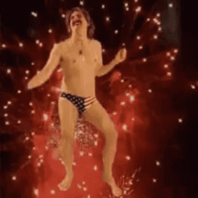A Shirtless Man In American Flag Underwear Is Dancing On A Red Floor . GIF