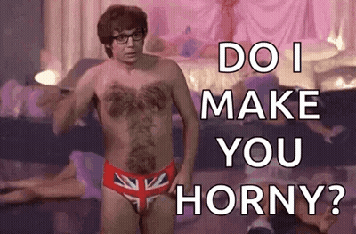 A Shirtless Man In British Flag Underwear Is Standing In Front Of A Bed And Asking Do I Make You Horny ? GIF