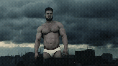 A Shirtless Man In Calvin Klein Underwear Stands In Front Of A City GIF