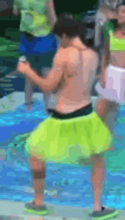 A Shirtless Man In Neon Yellow Shorts Is Dancing In The Water GIF