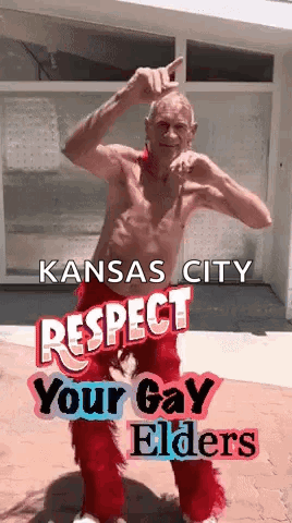 A Shirtless Man In Red Pants Is Dancing In Front Of A Building With The Words Kansas City Respect Your Gay Elders . GIF