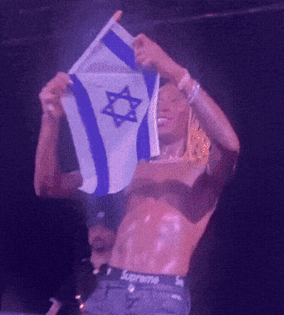 A Shirtless Man In Supreme Underwear Holds A Flag GIF