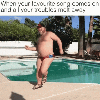 A Shirtless Man In Swim Trunks Is Dancing In Front Of A Pool . GIF
