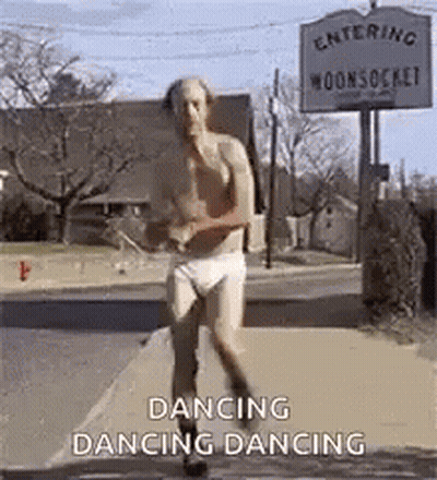 A Shirtless Man In Underwear Is Dancing On A Sidewalk In Front Of A Sign That Says Dancing Dancing . GIF