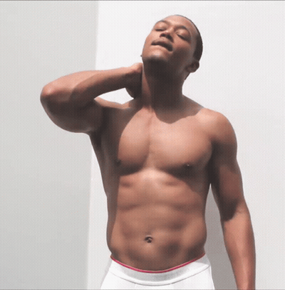 A Shirtless Man In White Calvin Klein Underwear Adjusts His Neck GIF