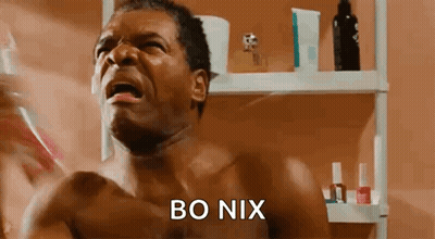 A Shirtless Man Is Brushing His Teeth In Front Of A Bathroom Mirror While Crying . GIF