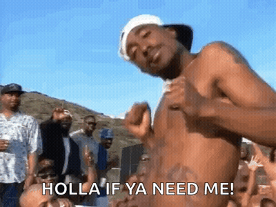 A Shirtless Man Is Dancing In Front Of A Crowd With The Words Holla If Ya Need Me Written On His Chest . GIF