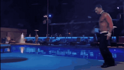A Shirtless Man Is Dancing In Front Of A Pool GIF