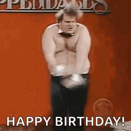 A Shirtless Man Is Dancing In Front Of A Red Wall And Says `` Happy Birthday ! '' GIF