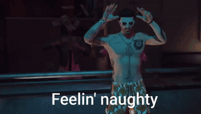 A Shirtless Man Is Dancing With The Words Feelin ' Naughty Above Him . GIF