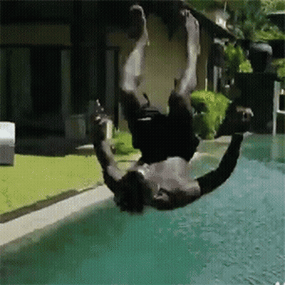 A Shirtless Man Is Doing A Handstand In A Pool GIF