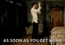 A Shirtless Man Is Doing A Handstand With A Cat . GIF