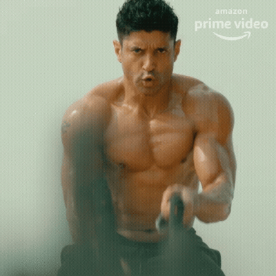 A Shirtless Man Is Doing Exercises In Front Of An Amazon Prime Video Advertisement GIF
