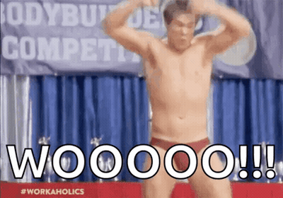 A Shirtless Man Is Flexing His Muscles In Front Of A Banner That Says Bodybuilder Competition GIF
