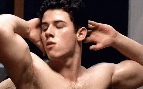 A Shirtless Man Is Flexing His Muscles With His Eyes Closed And His Hands On His Head . GIF