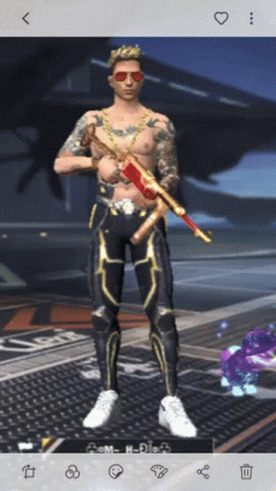 A Shirtless Man Is Holding A Gun And Wearing Sunglasses And A Chain Around His Neck GIF