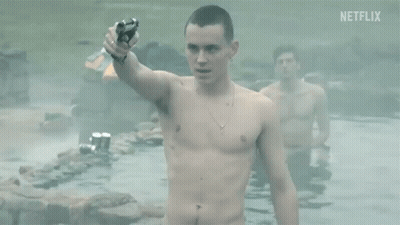 A Shirtless Man Is Holding A Gun While Standing In A Pool Of Water . GIF