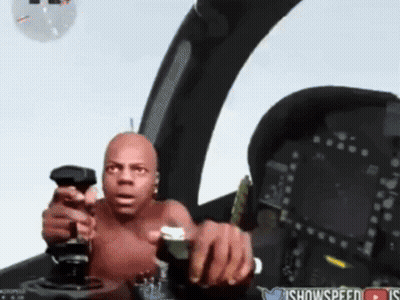A Shirtless Man Is Holding A Joystick In A Cockpit With A Twitter Icon In The Corner GIF