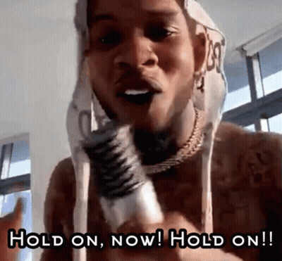 A Shirtless Man Is Holding A Microphone And Says Hold On Now Hold On !! GIF