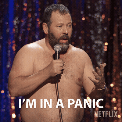 A Shirtless Man Is Holding A Microphone And Says I 'M In A Panic Netflix GIF