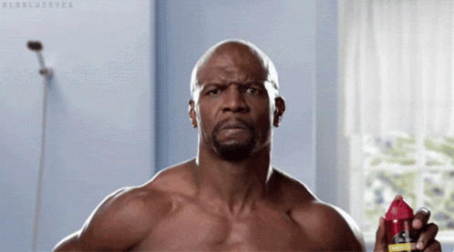 A Shirtless Man Is Holding A Shaving Razor In His Hand GIF