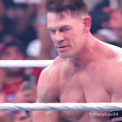 A Shirtless Man Is In A Boxing Ring With A Crowd Watching . GIF