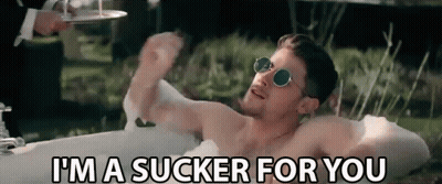 A Shirtless Man Is Laying In A Bathtub And Saying I 'M A Sucker For You . GIF