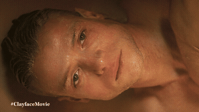 A Shirtless Man Is Laying In A Bathtub With #Clayfacemovie Written On The Bottom GIF