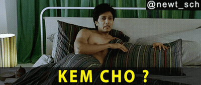 A Shirtless Man Is Laying On A Bed With A Striped Comforter And The Caption Kem Cho GIF