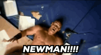 A Shirtless Man Is Laying On A Bed With The Words Newman Written Above Him GIF
