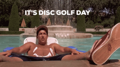 A Shirtless Man Is Laying On A Raft In A Pool With The Words It 'S Disc Golf Day Behind Him GIF