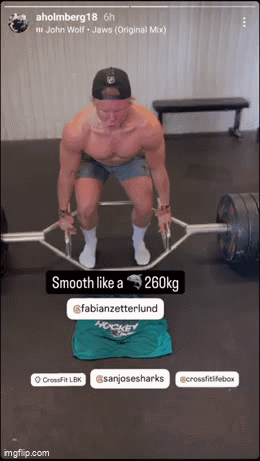 A Shirtless Man Is Lifting A Barbell In A Gym GIF