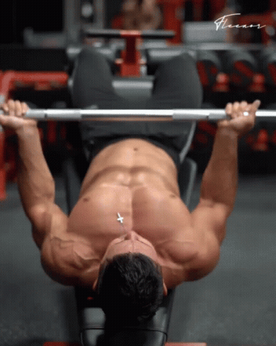 A Shirtless Man Is Lifting A Barbell In A Gym With The Word Fitness Written On The Bottom GIF