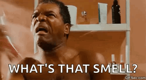 A Shirtless Man Is Screaming In Front Of A Bathroom Mirror And Asking What 'S That Smell . GIF