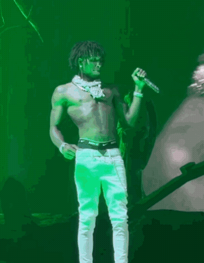 A Shirtless Man Is Singing Into A Microphone With Nike Underwear On GIF