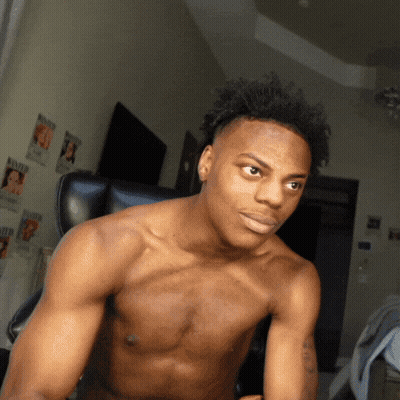 A Shirtless Man Is Sitting In A Chair In Front Of A Wall With Wanted Posters On It GIF